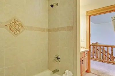 a bathroom with a shower with a tub at Mount Acoma 38 Condo in Estes Park