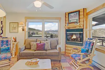a living room with a couch and a fireplace at Ptarmigan Mountain 202 Condo in Estes Park