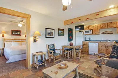 a room with a bed and a kitchen and a living room at Ptarmigan Mountain 202 Condo in Estes Park
