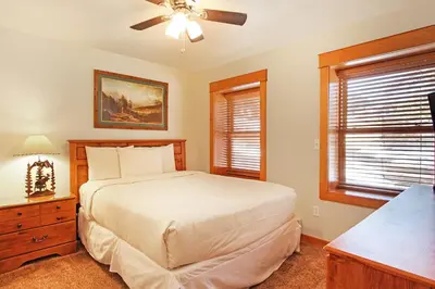 a bedroom with a bed and a ceiling fan at Little Matterhorn 17A Condo in Estes Park