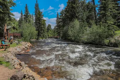 a river with rapids in the middle at Idlewilde by the River in Estes Park