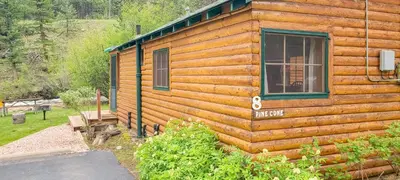 a log cabin with a window on the side of it at Idlewilde by the River in Estes Park