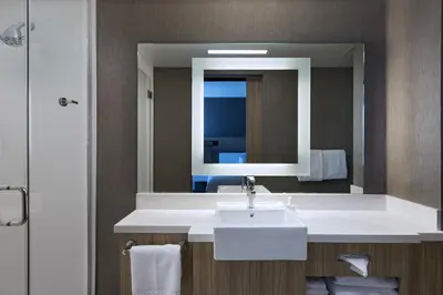 a bathroom with a white sink and a mirror at SpringHill Suites by Marriott Denver West/Golden in Lakewood