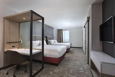 a hotel room with two beds and a desk and a tv at SpringHill Suites by Marriott Denver West/Golden in Lakewood