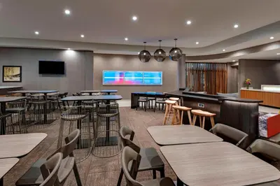 a restaurant with tables and chairs and a bar at SpringHill Suites by Marriott Denver West/Golden in Lakewood