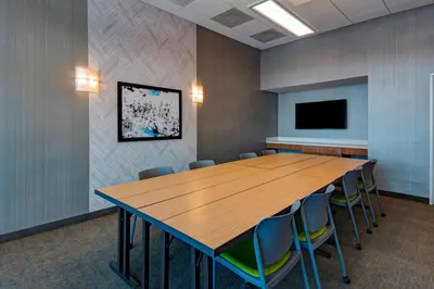 a conference room with a large wooden table and chairs at SpringHill Suites by Marriott Denver West/Golden in Lakewood
