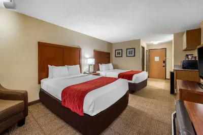 a hotel room with two beds and a television at Comfort Inn Denver Southeast Area in Aurora