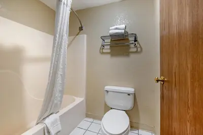 a bathroom with a toilet and a tub and a shower at Comfort Inn Denver Southeast Area in Aurora