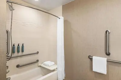a bathroom with a shower and a tub and a toilet at Residence Inn Denver Cherry Creek in Denver