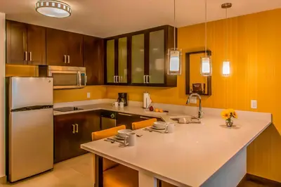 a kitchen with wooden cabinets and a white counter top at Residence Inn Denver Cherry Creek in Denver