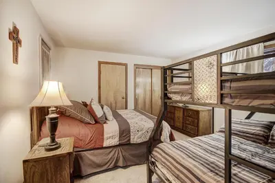a bedroom with two bunk beds and a lamp at 112 Marina Place Condo in Dillon