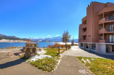 a building next to a body of water at 112 Marina Place Condo in Dillon