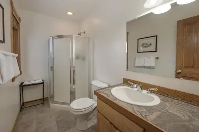 a bathroom with a toilet and a sink and a shower at Mountain Peak Home in Tabernash