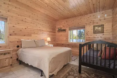 a bedroom with a bed in a wooden cabin at Mountain Peak Home in Tabernash