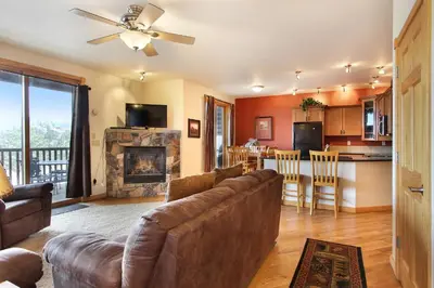 a living room with a couch and a fireplace at Chiefs Head Peak 21B Condo in Estes Park