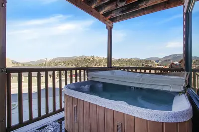 a hot tub on the deck of a house at Nakai Peak 41B Condo in Estes Park