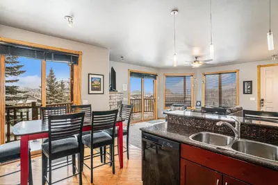 a kitchen with a table and chairs and a counter at Nakai Peak 41B Condo in Estes Park