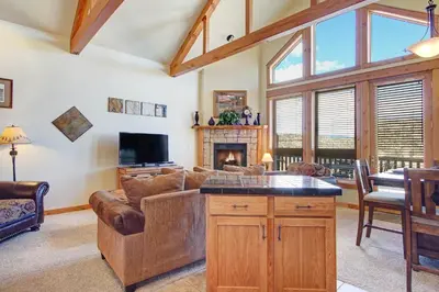 a living room with a couch and a tv at Mount Enentah 37 Condo in Estes Park