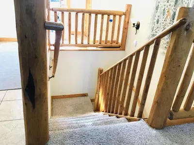 a set of wooden stairs in a house at Mount Enentah 37 Condo in Estes Park