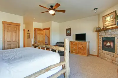 a bedroom with a bed and a fireplace at Mount Enentah 37 Condo in Estes Park