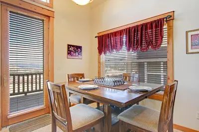 a dining room with a table and chairs and a window at Mount Enentah 37 Condo in Estes Park