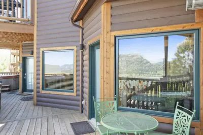 a patio with a table and chairs on a deck at Horsetooth Peak 26C Condo in Estes Park