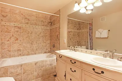 a bathroom with a tub and a sink and a tub and a toilet at Horsetooth Peak 26C Condo in Estes Park