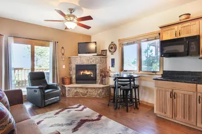 a living room with a fireplace and a couch at Lookout Mountain 27B Condo in Estes Park