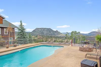 a swimming pool with a view of the mountains at Lookout Mountain 27B Condo in Estes Park