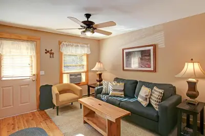 a living room with a couch and a table at Snowdrift Peak 203 Condo in Estes Park