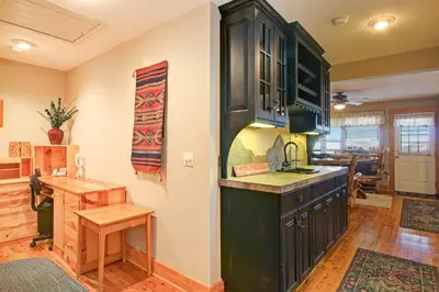 a kitchen with green cabinets and a counter top at Snowdrift Peak 203 Condo in Estes Park