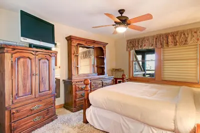 a bedroom with a bed and a tv on a dresser at Snowdrift Peak 203 Condo in Estes Park