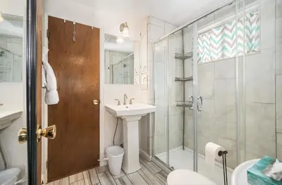 a bathroom with a shower and a sink and a toilet at Starlight In The Rockies in Estes Park