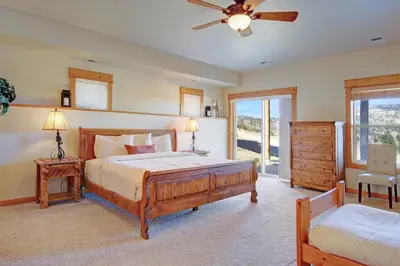 a bedroom with two beds and a ceiling fan at Nisa Mountain 36 Condo in Estes Park