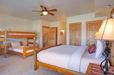 a bedroom with two beds and a ceiling fan at Nisa Mountain 36 Condo in Estes Park