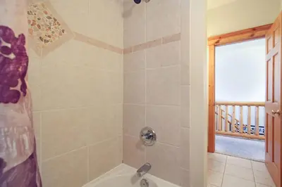 a bathroom with a shower with a tub at Nisa Mountain 36 Condo in Estes Park