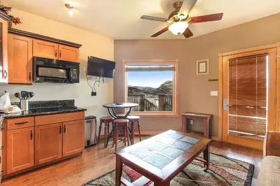 a kitchen with a ceiling fan and a table and chairs at Macgregor Mountain 27C Condo in Estes Park