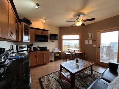 a kitchen and living room with a table at Macgregor Mountain 27C Condo in Estes Park