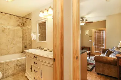 a bathroom with a tub and a sink and a bath tub at Macgregor Mountain 27C Condo in Estes Park