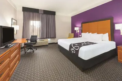 a hotel room with a large bed and a flat screen tv at La Quinta Inn by Wyndham Denver Westminster in Westminster