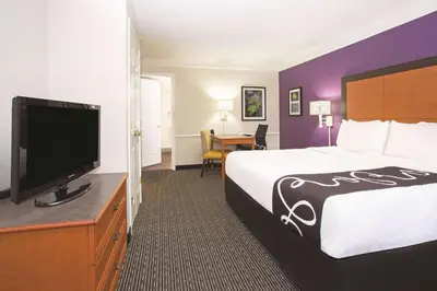 a hotel room with a bed and a flat screen tv at La Quinta Inn by Wyndham Denver Westminster in Westminster