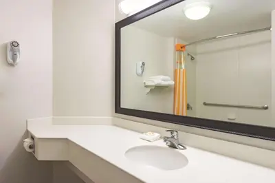 a bathroom with a sink and a large mirror at La Quinta Inn by Wyndham Denver Westminster in Westminster