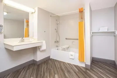 a bathroom with a sink and a tub and a shower at La Quinta Inn by Wyndham Denver Westminster in Westminster