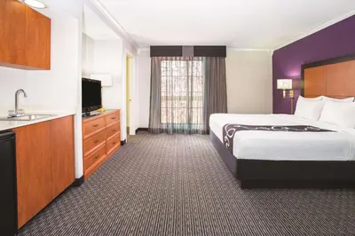 a hotel room with a bed and a sink at La Quinta Inn by Wyndham Denver Westminster in Westminster