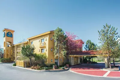 a hotel with a clock tower and a parking lot at La Quinta Inn by Wyndham Denver Westminster in Westminster