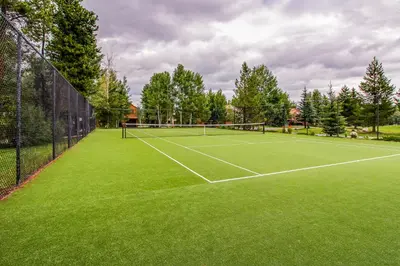 a tennis court with a net on a green field at Mountainside D257 in Frisco