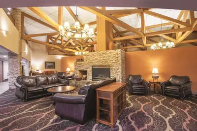 a living room with leather furniture and a fireplace at Mountain Valley Inn & Suites in Silverthorne