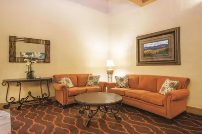 a living room with two couches and a table at Mountain Valley Inn & Suites in Silverthorne