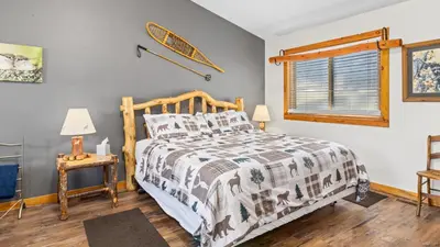 a bedroom with a bed and a window at Mountain Shadows Resort in Estes Park