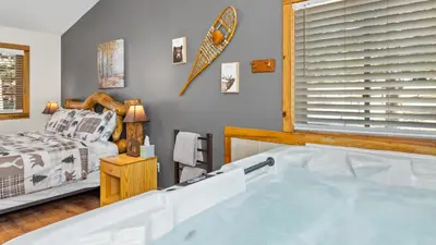 a bath tub in a room with a bed at Mountain Shadows Resort in Estes Park